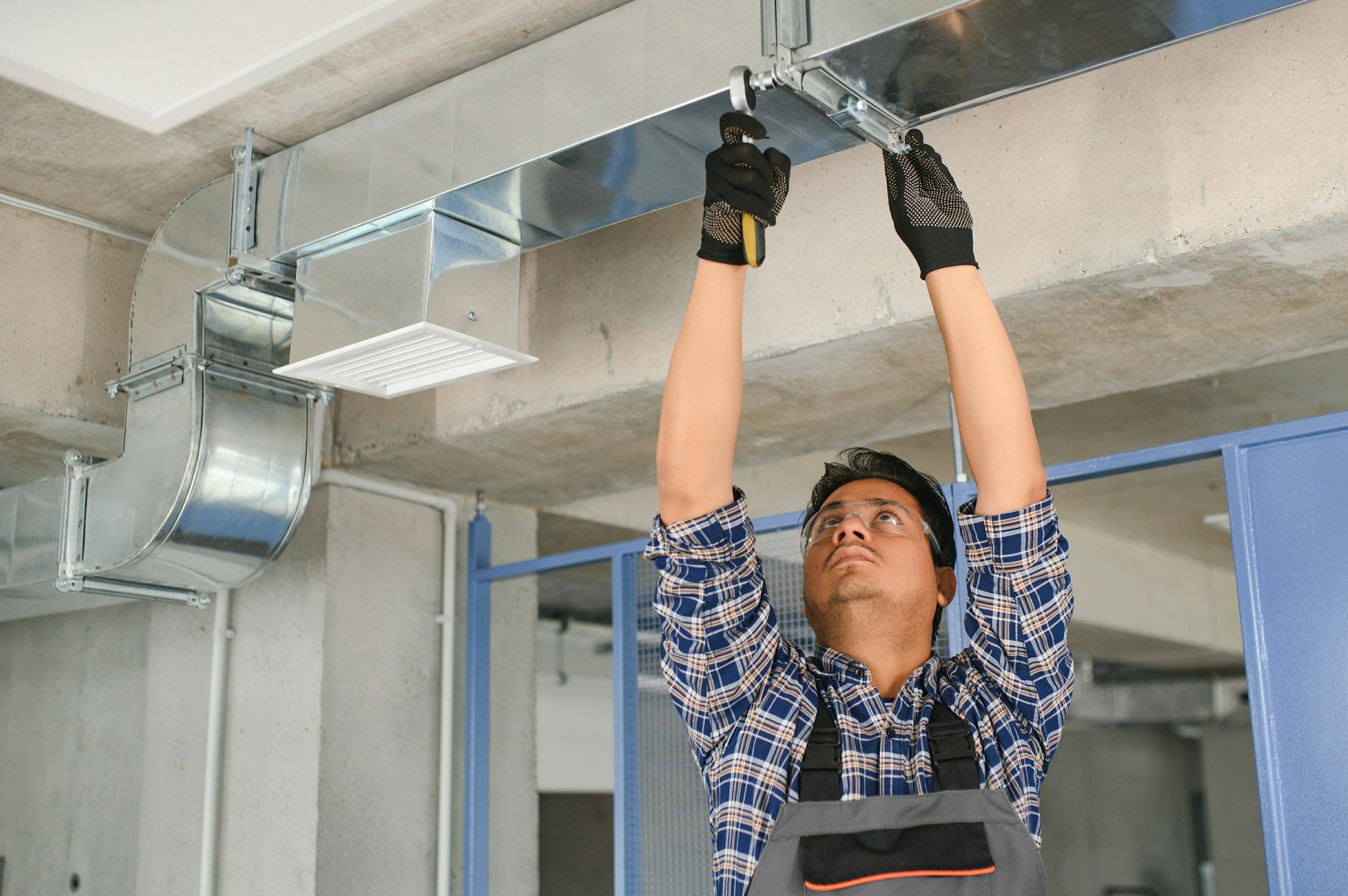 Ventilation cleaning. Specialist at work. Repair ventilation system (HVAC). Industrial background